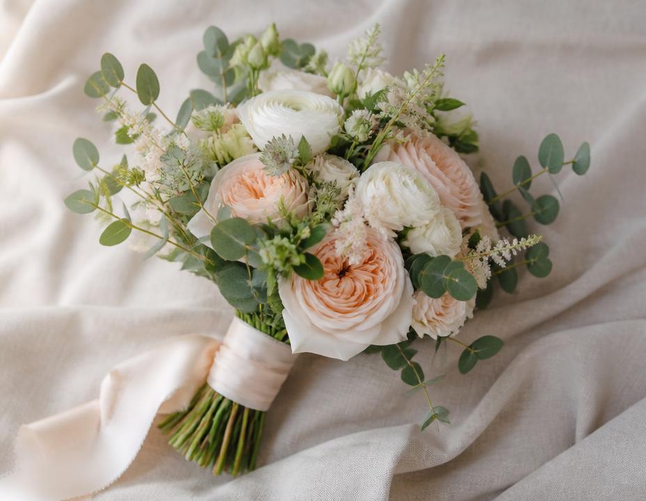 Hand-tied bridal bouquet of blush garden roses and eucalyptus